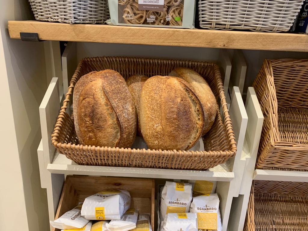Baskets of fresh sourdough loaves at The Italian Club Bakery