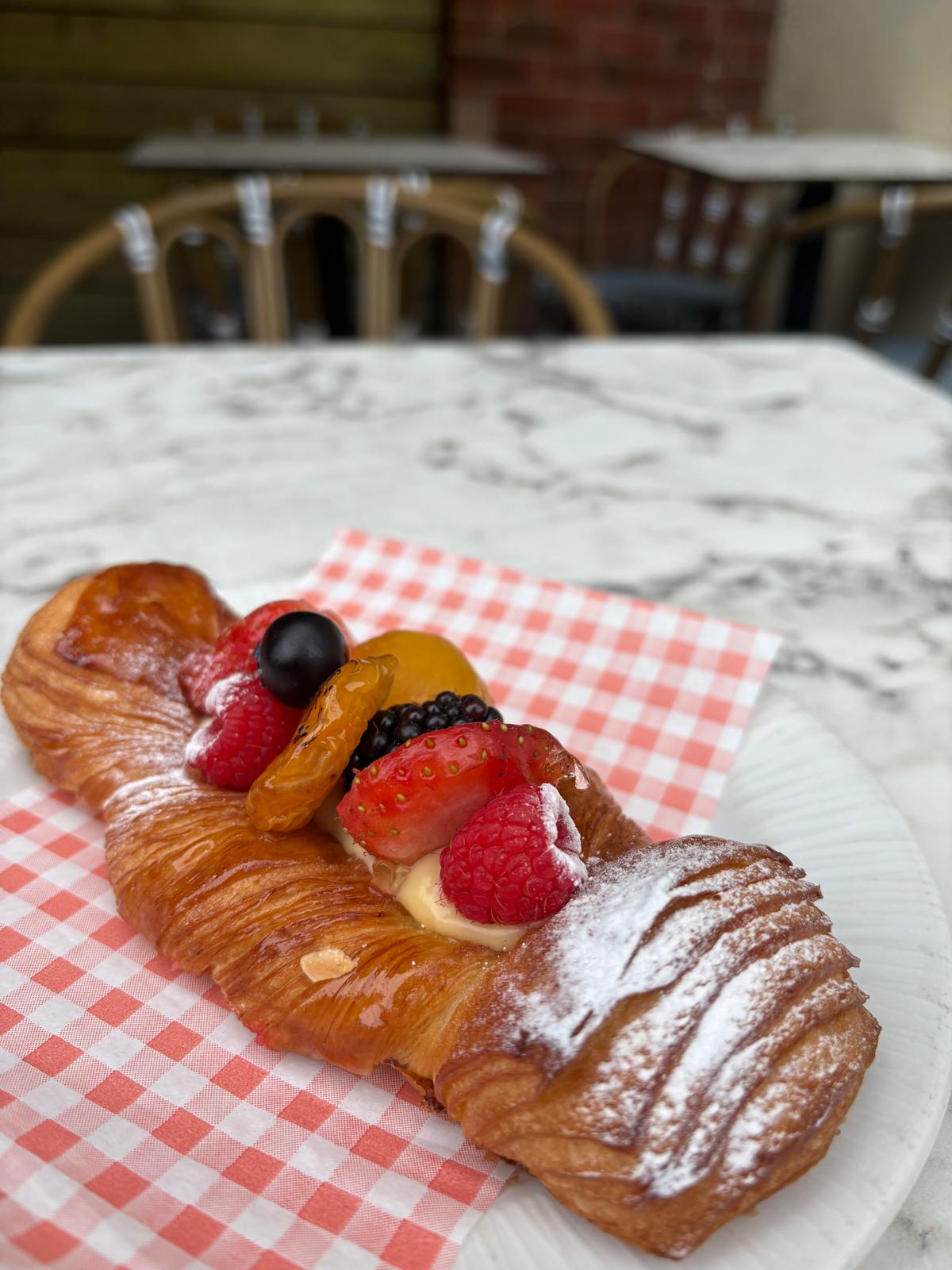 Box of assorted Italian pastries with fresh berries
