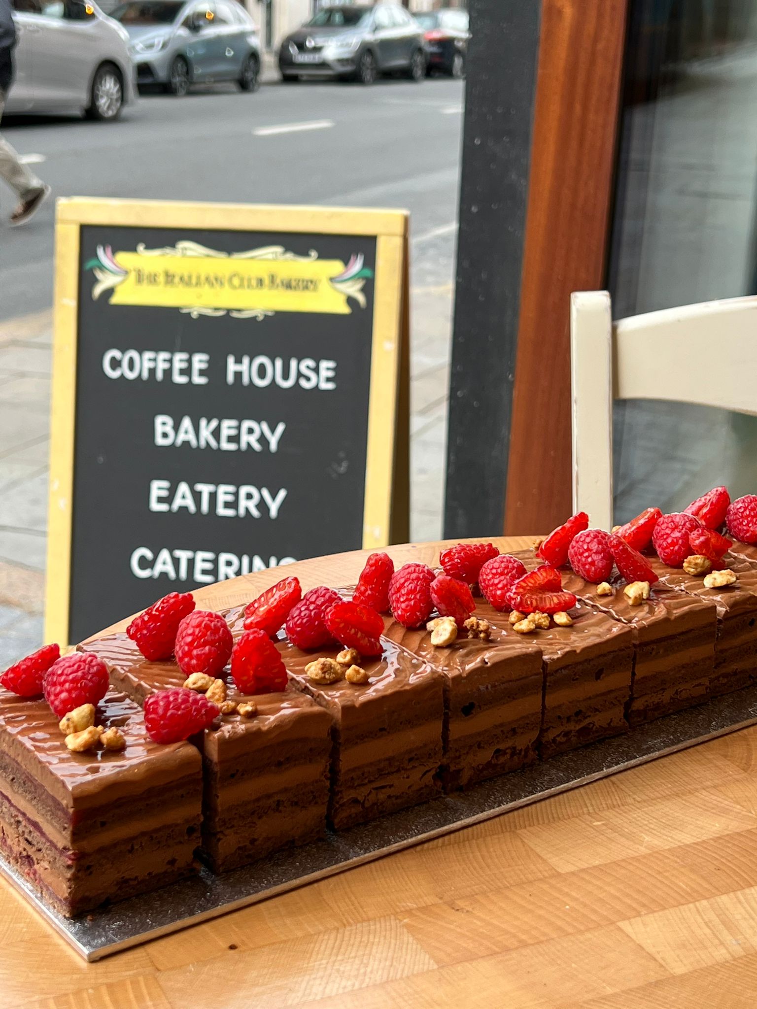 Chalkboard sign: coffee house, bakery, eatery, catering