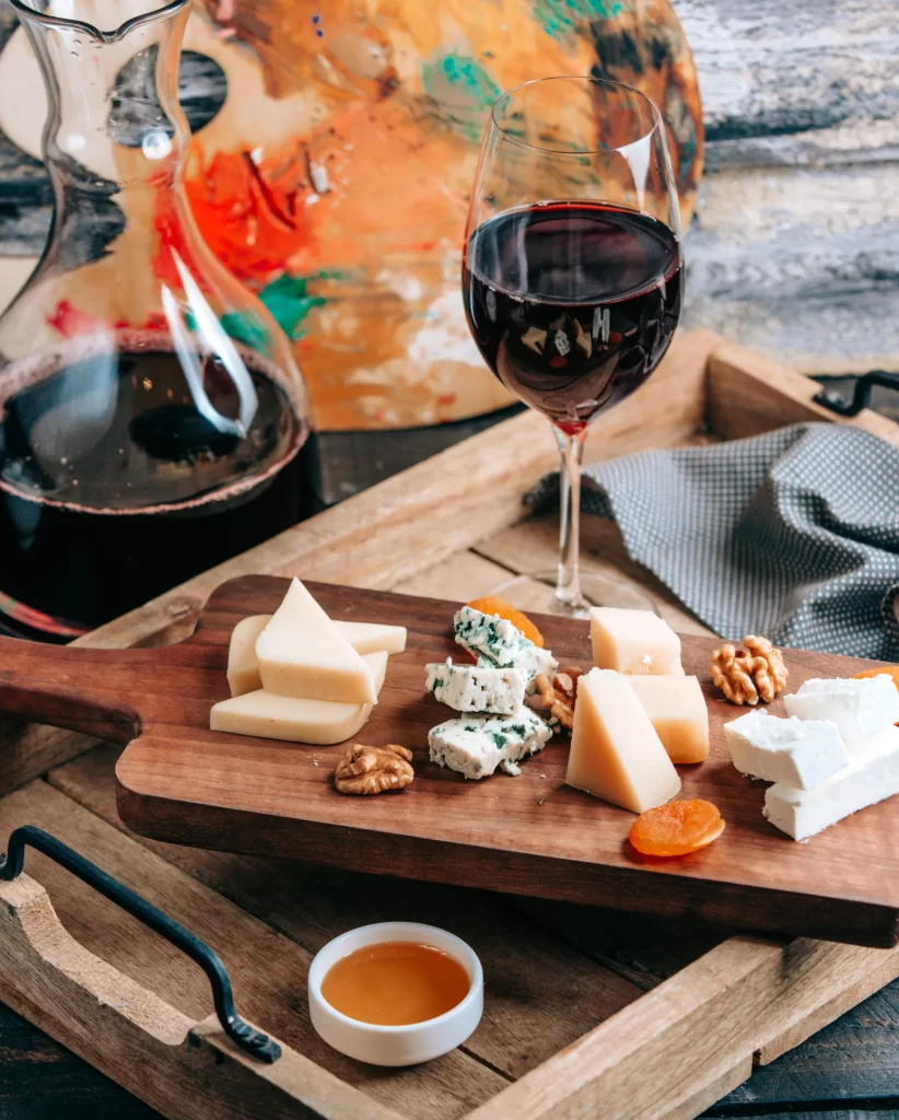 Italian cheese board with a glass of red wine