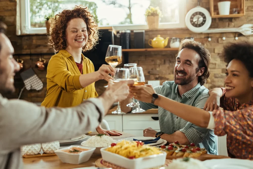 Friends raising a glass of wine over an Italian lunch